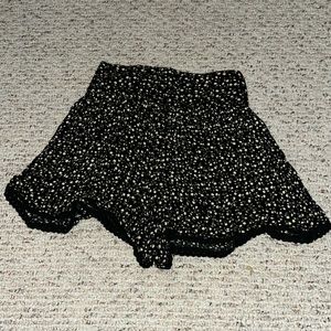 Black shorts with yellow and white flowers, size small